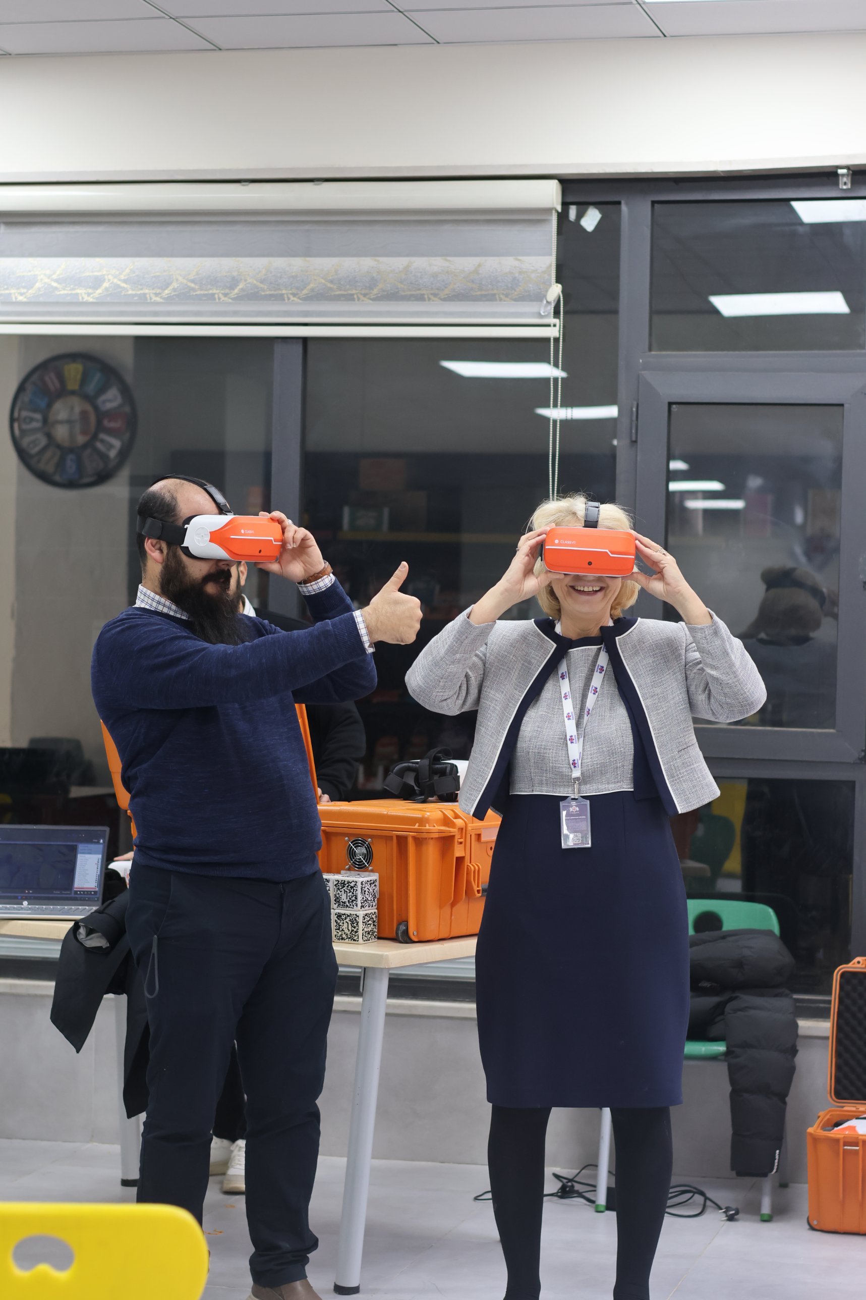 Staff trying classroom VR headsets during a training session